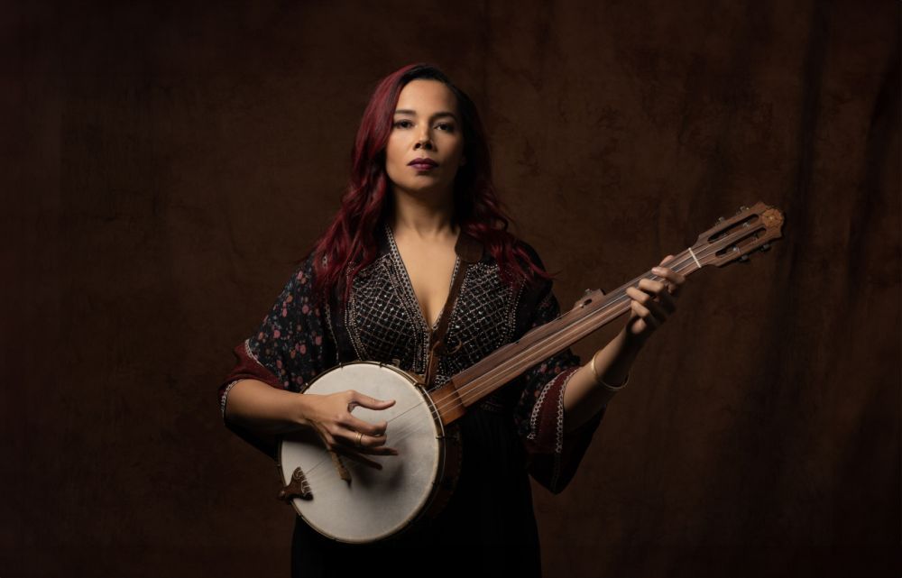 Rhiannon Giddens poses with her banjo. 