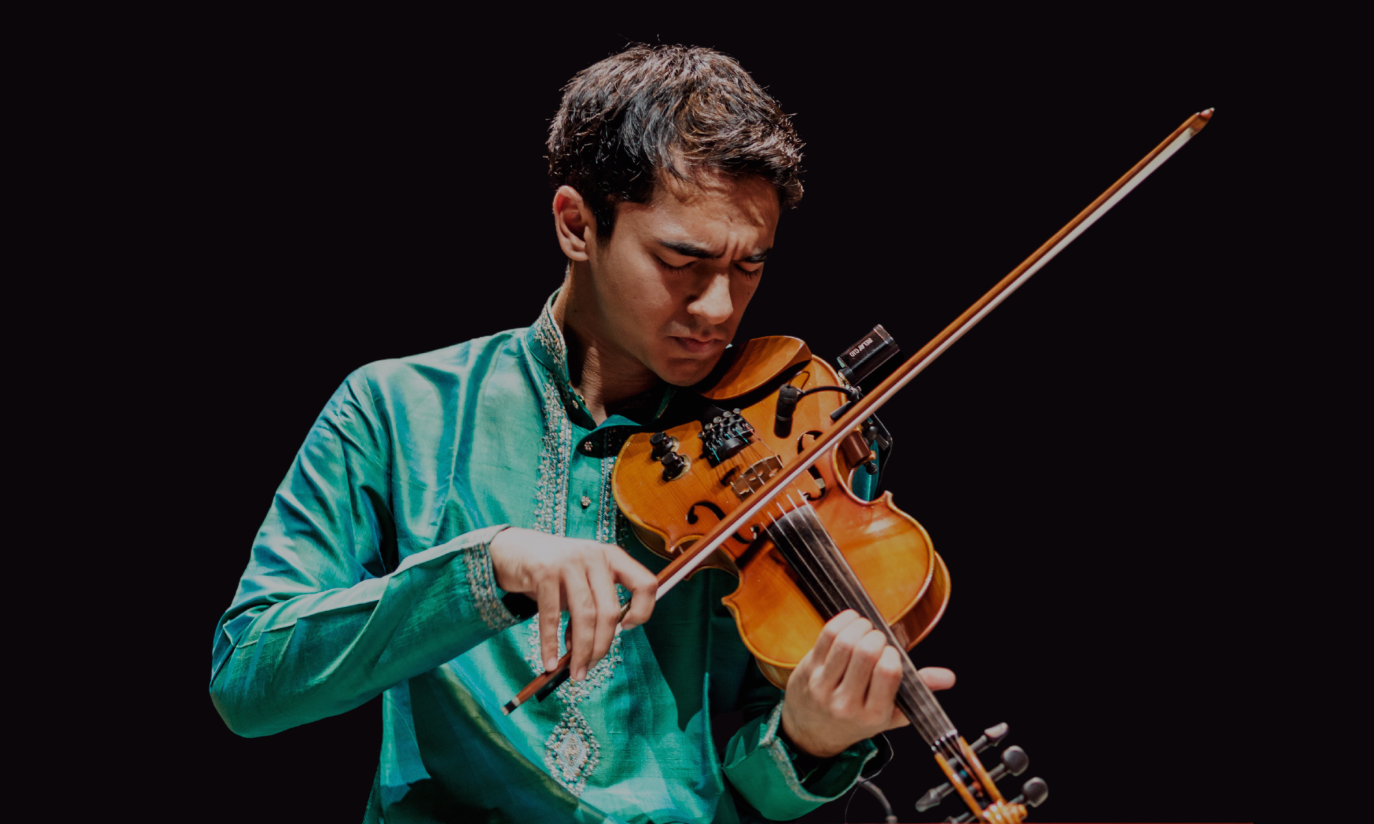 Image of Ambi Subramaniam playing the violin. 