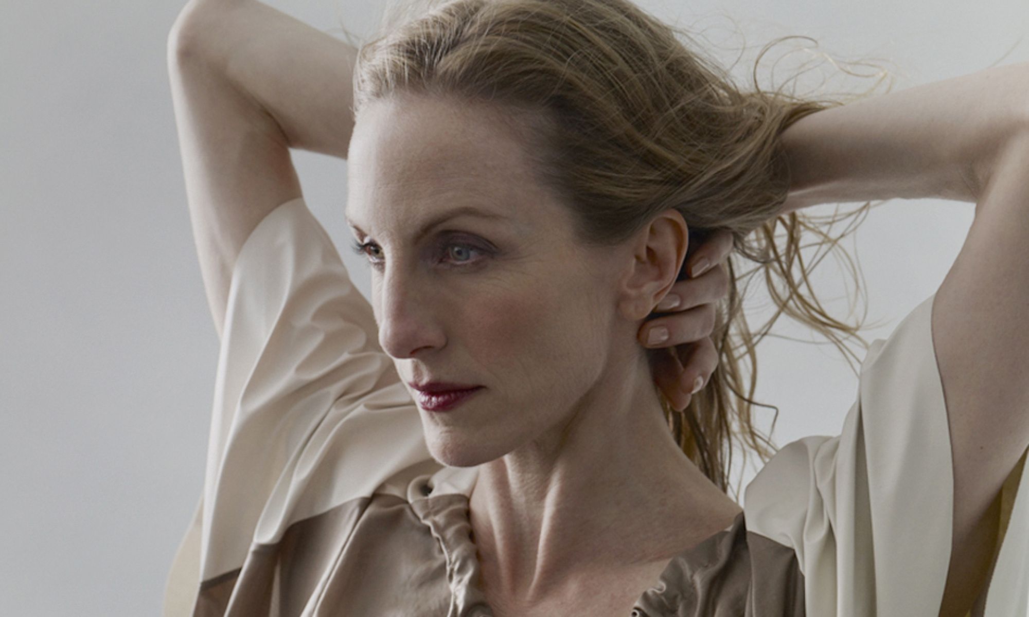 Image of Wendy Whelan with her arms behind her neck. 